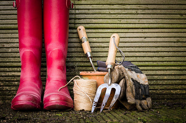 Essential gardening tools and supplies including red boots, gloves, twine, and hand tools for container gardening.