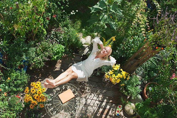 Relaxing in a lush balcony container garden surrounded by vibrant flowers – real lessons on managing summer heat stress in potted plants