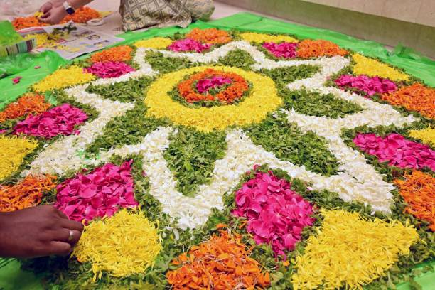 Eco-friendly Diwali rangoli made with flower petals and leaves placed near potted plants, showing sustainable festive decor ideas for balconies.